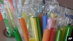 FILE - Wrapped plastic straws at a bubble tea cafe in San Francisco, July 17, 2018. A law signed Thursday by Gov. Jerry Brown makes California the first state to bar full-service restaurants from automatically giving out single-use plastic straws. It takes effect next year.