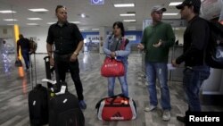 Cuban migrants arrive after traveling en route from Costa Rica to El Salvador, Guatemala and Mexico, before heading to the U.S., at General Lucio Blanco International airport in Reynosa, in Tamaulipas state, Mexico, Jan. 17, 2016. 