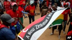 FILE - Opposition Movement for Democratic Cahne (MDC) party supporters wave flags at a rally to launch their election campaign in Harare, Zimbabwe, Jan. 21, 2018. 