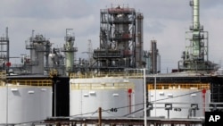 FILE - Storage tanks are shown at a refinery in Detroit, April 21, 2020.