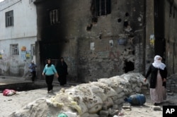 FILE - People emerge from their homes following the lifting of a curfew in the mainly Kurdish town of Cizre, Turkey, Sept. 12, 2015.