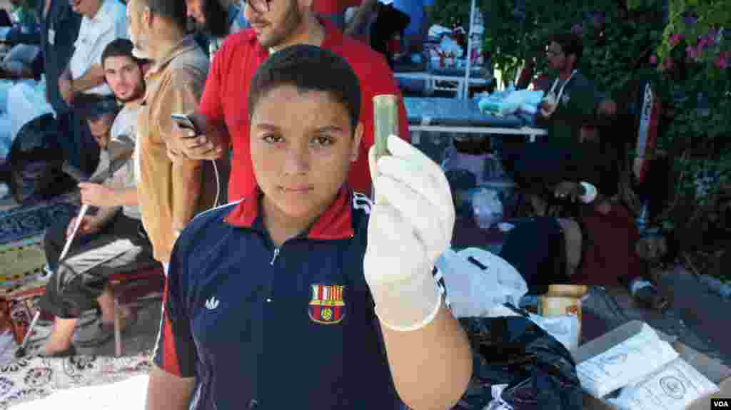 A boy shows a shotgun shell after clashes between Morsi supporters and security forces in Cairo, July 27, 2013, (Elizabeth Arrott/VOA).