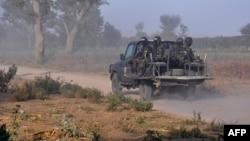 FILE - Members of the Cameroonian Rapid Intervention Force patrol on the outskirt of Mosogo in the Far North region of the country where Boko Haram jihadist have been active since 2013, March 21, 2019.