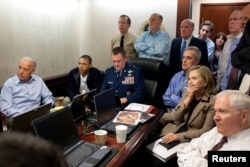 U.S. President Barack Obama (2nd L) and Vice President Joe Biden (L), along with members of the national security team, receive an update on the mission against Osama bin Laden in the Situation Room of the White House, May 1, 2011.