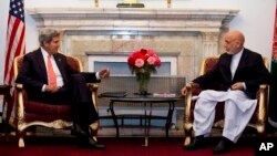 U.S. Secretary of State John Kerry, left, meets with Afghan President Hamid Karzai at the Presidential Palace during an unannounced stop in Kabul, Afghanistan, Oct. 11, 2013.