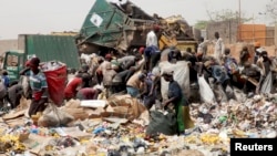 Scavengers work picking up trash for recycling at the Olusosun dump site in Nigeria's commercial capital Lagos, March 23, 2012.