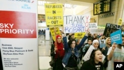 Demonstrators opposed to President Trump's travel ban march through Tom Bradley International Terminal at Los Angeles International Airport, Feb. 4, 2017. One sign thanks federal judge James L. Robart, who issued a stay of the order.