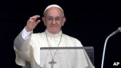 Pope Francis recites the Angelus noon prayer from the window of his studio overlooking St. Peter's Square, at the Vatican, July 23, 2017. 