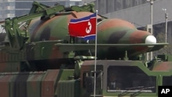 In this photo taken Sunday, April 15, 2012, what appears to be a new missile is carried during a mass military parade at the Kim Il Sung Square in Pyongyang, North Korea, to celebrate the 100th anniversary of the country's founding father Kim Il Sung. The photo shows the warhead's surface is undulated, suggesting it's a thin metal sheet unable to withstand flight pressure, analysts say. Adding more doubt to North Korea's claims of military prowess after its flamboyant rocket launch failure, analysts say the half dozen missiles showcased at the military parade were low-quality fakes. (AP Photo/Ng Han Guan)