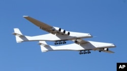 Stratolaunch makes its historic first flight from the Mojave Air and Space Port in Mojave, Calif., Saturday, April 13, 2019. (AP Photo/Matt Hartman)