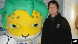 New Zealand fan Pam Sceats poses with the South African World Cup mascot, Zakumi