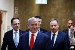 FILE - Israeli Prime Minister Benjamin Netanyahu arrives for his cabinet's weekly meeting, in Jerusalem, April 14, 2019.