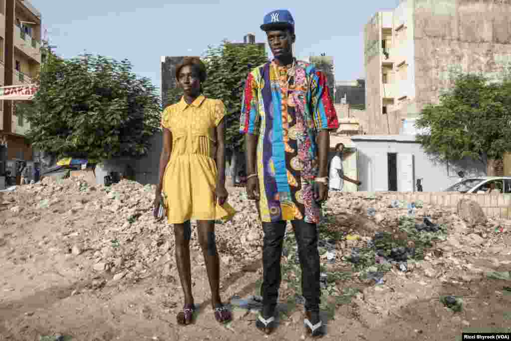 Katy and Fallou pose for a portrait in Dakar&#39;s Niary Tally neighborhood, the working class area where Dakar Fashion Week held their &quot;Street Show&quot; fashion show this year, June 29, 2017.