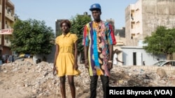 Katy and Fallou pose for a portrait in Dakar's Niary Tally neighborhood, the working class area where Dakar Fashion Week held their "Street Parade" fashion show this year, June 29, 2017.