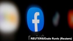 A Facebook logo is displayed on a smartphone