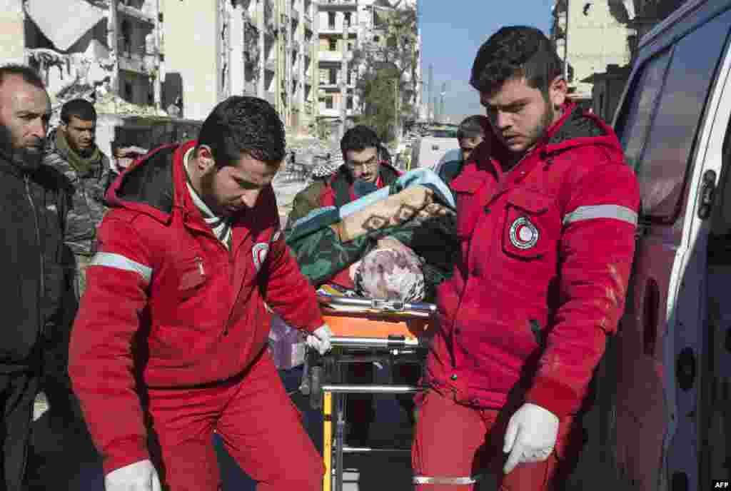 Staff of the Syrian Red Crescent pulls a stretcher with a wounded person during an evacuation operation of rebel fighters and their families from rebel-held neighbourhoods in the embattled city of Aleppo on Dec. 15, 2016.