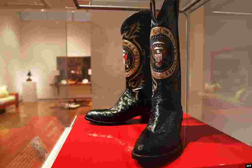 A pair of Ronald Reagan&#39;s cowboy boots sit in a case at Christie&#39;s where items from the former U.S. president and Nancy Reagan&#39;s California home are to be auctioned in New York City. Proceeds from the auction will be donated to the Ronald Reagan Presidential Foundation and Institute.