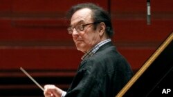 FILE - Chief conductor Charles Dutoit rehearses with the Philadelphia Orchestra in Philadelphia, Oct. 19, 2011.