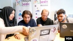 Ibrahim Ouassari (2-L) is the founder of the "MolenGeek" project, teaching young people about IT and entrepreneurship, Brussels, Belgium, Sept. 2016. (M. van der Wolf/VOA)