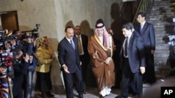 Saudi Arabian Foreign Minister Saud al-Faisal, center, arrives to attend an Arab League's emergency meeting in Cairo, March 12, 2011