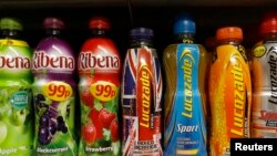 FILE - Soft drinks in bottles are displayed on a shelf in a shop in London, April 24, 2013. 