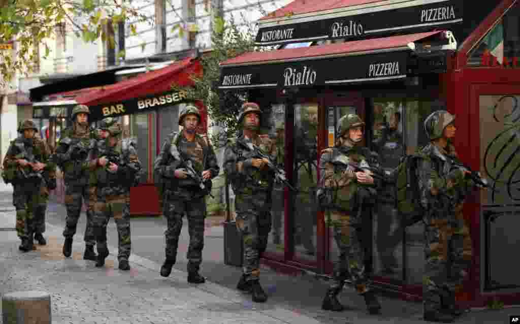 Soldiers launch operation in St. Denis, a northern suburb of Paris, Nov. 18, 2015. 