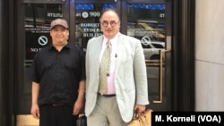 Guillermo Peralta poses with his pro-bono lawyer, Craig Shagin, at the entrance of the U.S. Immigration Court in Philadelphia.