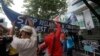 FILE - Demonstrators, carrying a boat, rally outside the Chinese Consulate in the financial district of Makati city, east of Manila, Philippines, to protest China's territorial claims in the South China Sea, July 3, 2015. 