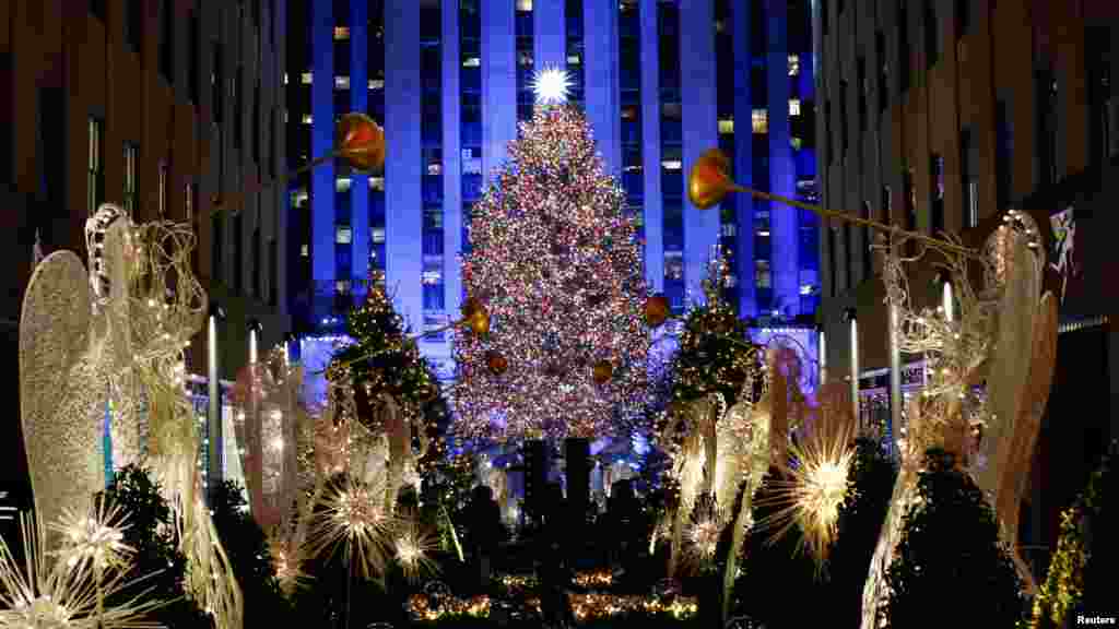 People watch the Christmas tree lighting at Rockefeller Center in the Manhattan area of New York City, November 28, 2018.