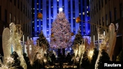 People watch the Christmas tree lighting at Rockefeller Center in the Manhattan borough of New York City, New York, U.S., November 28, 2018. 