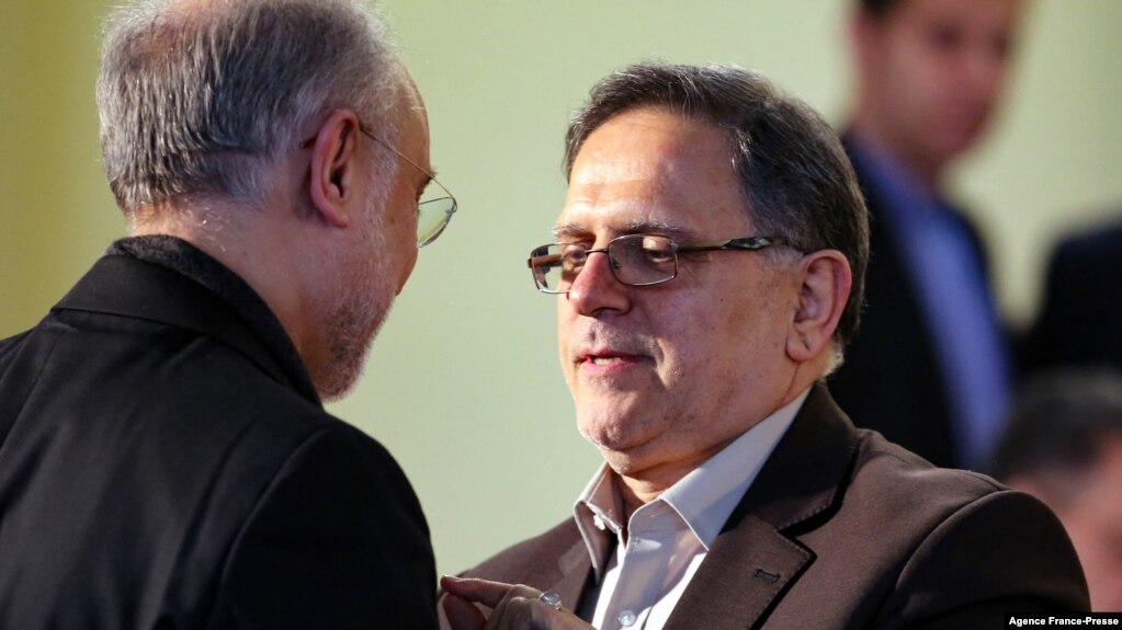 FILE - Then-head of the Central Bank of Iran, Valliollah Seif (R), speaks to Iran's head of its Atomic Energy Organisation Ali Akbar Salehi, in Tehran, Iran Jan. 17, 2016.