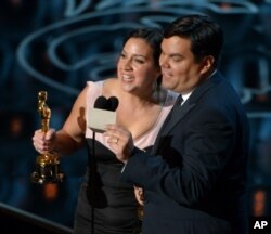 Kristen Anderson-Lopez, left, and Robert Lopez accept the award for Best Original Song in a Feature Film for "Let It Go" from "Frozen" during the Oscars at the Dolby Theatre on March 2, 2014, in Los Angeles. (Photo by John Shearer/Invision)