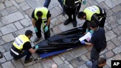 Israeli emergency services remove the body of an alleged Palestinian attacker in Jerusalem Friday, Feb. 19, 2016. The Palestinian stabbed two officers before he was shot and killed, police said.