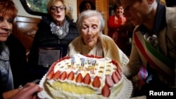 Emma Morano, thought to be the world's oldest person and the last to be born in the 1800s, blows candles during her 117th birthday in Verbania, northern Italy November 29, 2016. 
