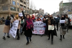 FILE - Afghan women march as they chant slogans and hold banners during a women's rights protest in Kabul, Jan. 16, 2022.