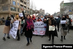 FILE - Afghan women march as they chant slogans and hold banners during a women's rights protest in Kabul, Jan. 16, 2022.