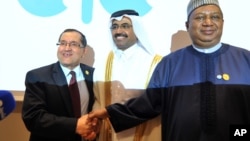 FILE -- Algerian Energy Minister Noureddine Boutarfa, left, Bin Saleh Al-Sada, Minister of Energy and Industry of Qatar, center, and acting Secretary General of OPEC Mohammed Barkindo, right, shake hands at the end of a meeting of oil ministers of the Organization of Petroleum Exporting Countries in Algiers, Algeria, September 28, 2016.