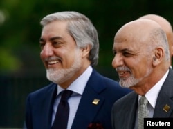FILE - Afghanistan's President Ashraf Ghani, right, and Chief Executive Abdullah Abdullah arrive for a NATO summit in Warsaw, Poland, July 9, 2016.