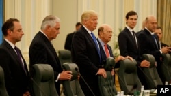 President Donald Trump waits for the beginning of a bilateral meeting with Saudi King Salam at the Royal Court Palace, Saturday, May 20, 2017, in Riyadh. From left are, White House Chief of Staff Reince Priebus, Secretary of State Rex Tillerson, Trump, Commerce Secretary Wilbur Ross, White House senior adviser Jared Kushner, and Chief Economic Adviser Gary Cohn.