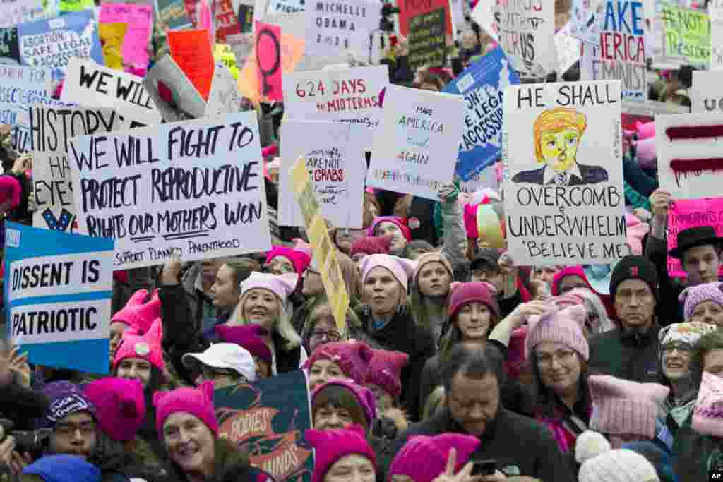 Women with pink hats and signs begin to gather early and are set to make their voices heard on the first full day of Donald Trump's presidency, Jan. 21, 2017 in Washington. 