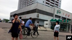 Residents go about their business near one of the city’s biggest department stores and shopping areas in Pyongyang, North Korea, June 10, 2018. 