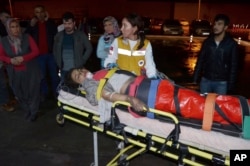Medics carry a wounded student to an ambulance in Aladag, Adana, in southern Turkey, Nov. 29, 2016. A fire at a middle school dormitory for girls in southern Turkey left at least 12 people dead.