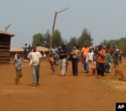 Refugees walk down the main street in the Gasorwe Refugee Camp in northern Burundi.