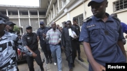 Laurent Akoun, center, a top FPI official, after his trial at a court in Abidjan, August 31, 2012.