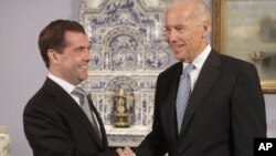 U.S. Vice President Joe Biden (R) shakes hands with Russia's President Dmitry Medvedev during their meeting in the presidential residence at Gorki, outside Moscow March 9, 2011.