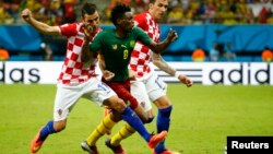 Croatia's Darijo Srna (L) and Mario Mandzukic fight for the ball with Cameroon's Benjamin Moukandjo during their 2014 World Cup Group A soccer match at the Amazonia arena in Manaus June 18, 2014. REUTERS/Murad Sezer (BRAZIL - Tags: SOCCER SPORT WORLD CUP