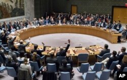 FILE - In this photo provided by the United Nations, members of the United Nations Security council vote at the United Nations headquarters on Friday, Dec. 23, 2016, in favor of condemning Israel for its practice of establishing settlements in the West Bank.