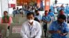 Warga antre untuk mendapatkan vaksin COVID produksi AstraZeneca pada vaksinasi massal di Terminal Kampung Rambutan, Jakarta (15/6).