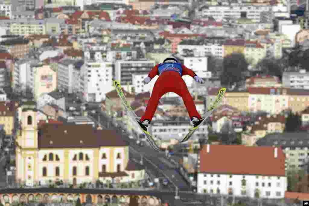 Killian Peier of Switzerland soars through the air during his trial jump at the third stage of the 70th Four Hills ski jumping tournament in Innsbruck, Austria.