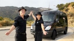 Natcha Morrow (left), a Thai co-owner of sightseeing tour company in Los Angeles stands in front of tour van with her American husband Mark Morrow